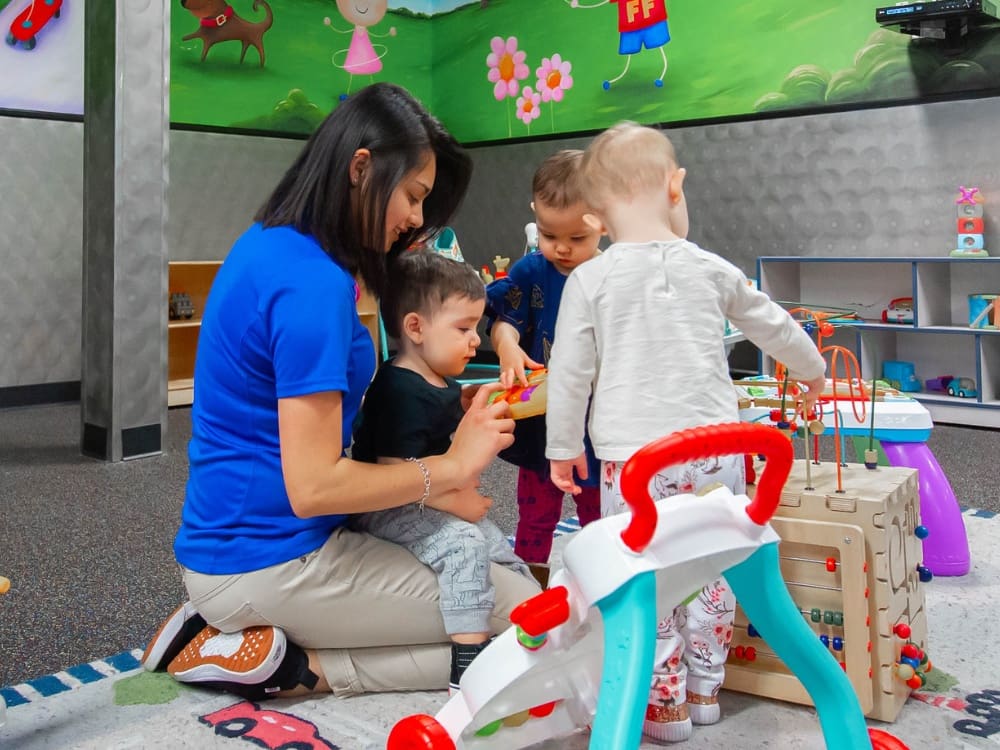 kids play with an onsite childcare worker at freedom fitness gym in airline corpus christi