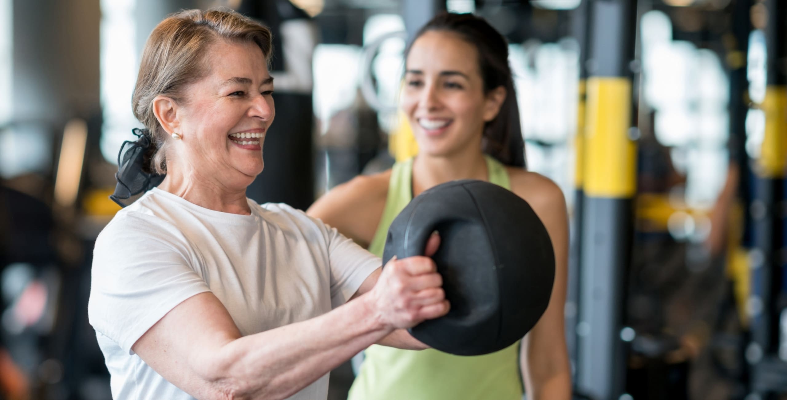 a personal trainer works with a gym member at freedom fitness gym in corpus christi