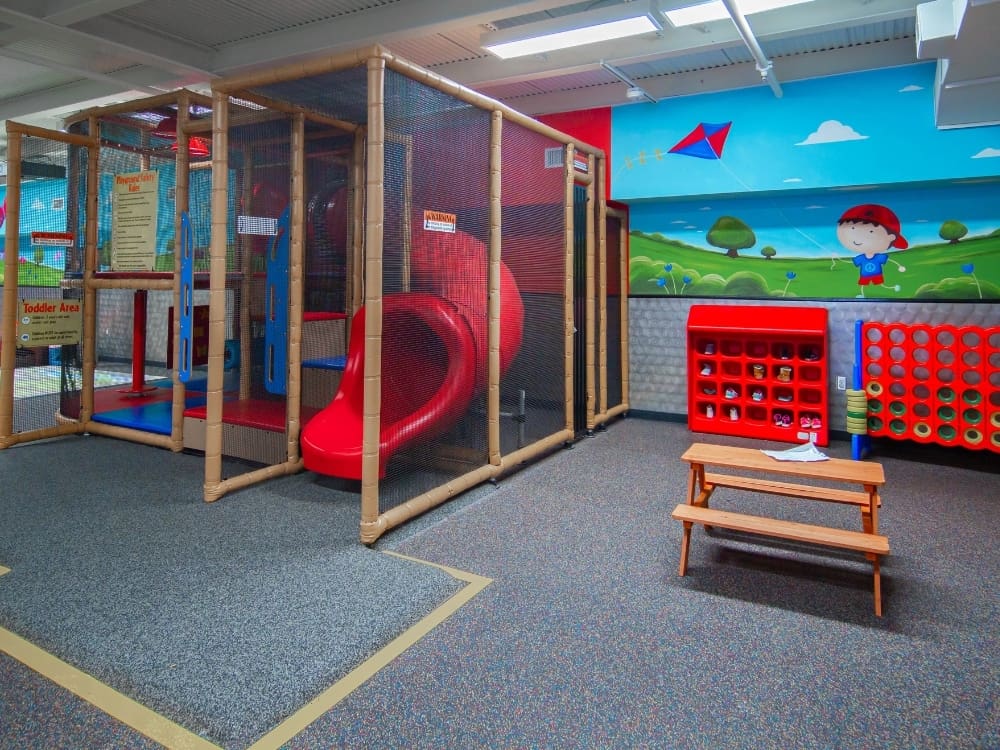 a slide and play area in the onsite childcare area at freedom fitness gym in airline corpus christi