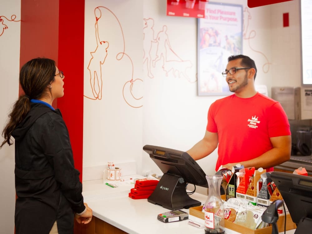 a gym member gets a healthy snack at the smoothie bar at freedom fitness gym in airline corpus christi