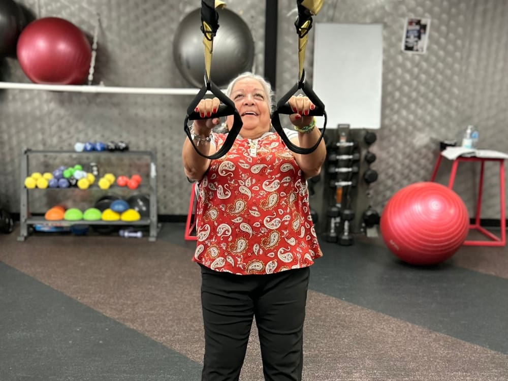 a gym member uses resistance bands for a functional training workout at freedom fitness gym in alameda corpus christi