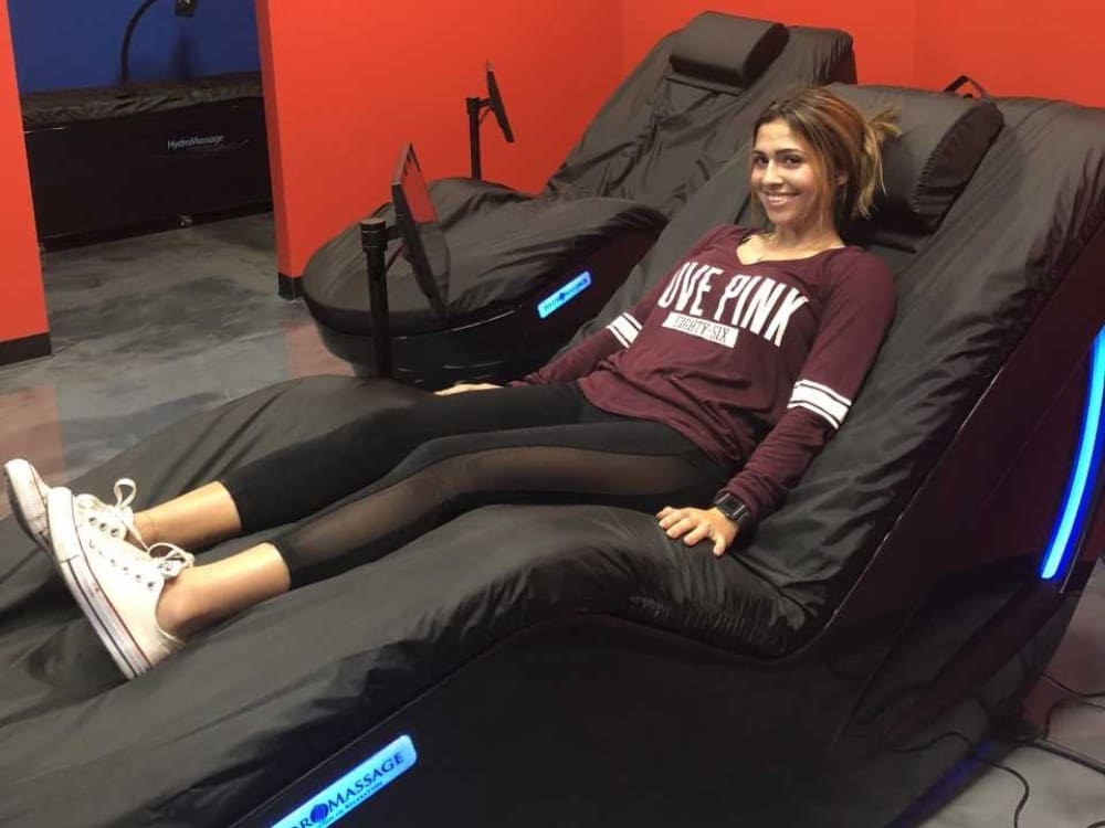 a gym member enjoys hydromassage therapy at a gym in calallen