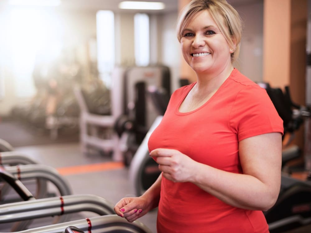 a woman runs on a treadmill at a gym near me with cardio training in calallen