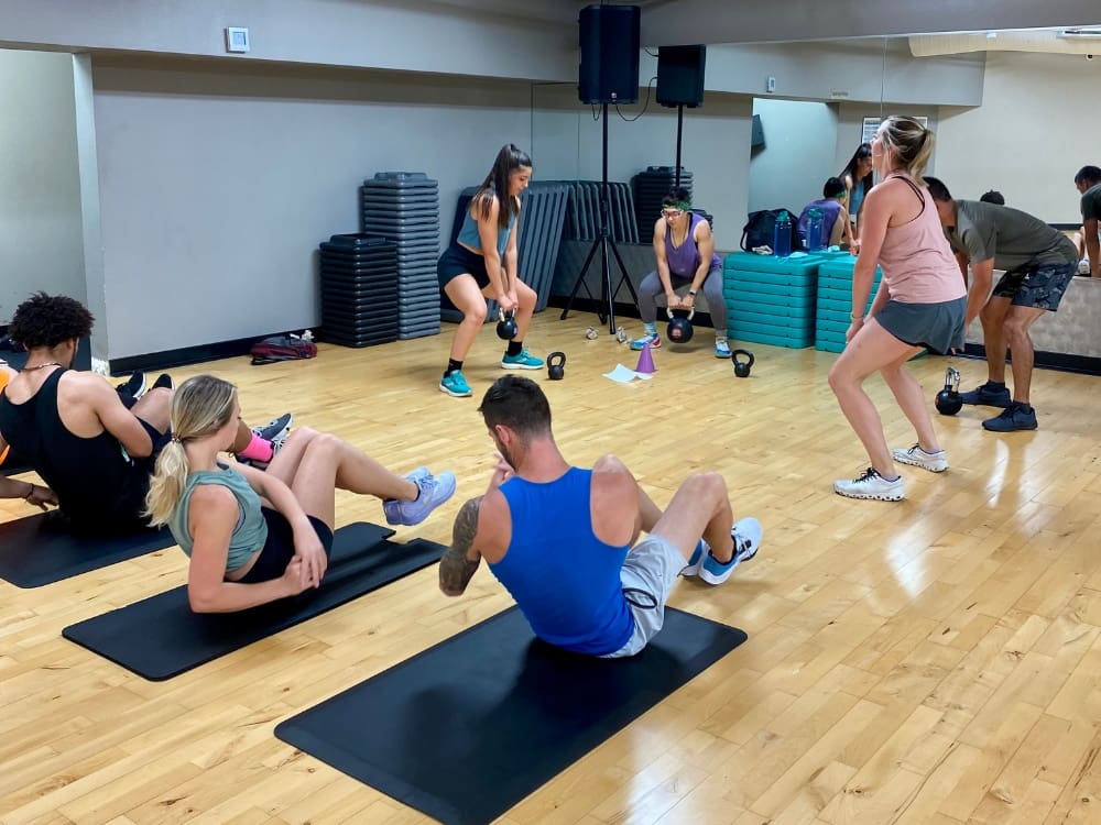 a small group training session in a group fitness studio at a gym near me calallen