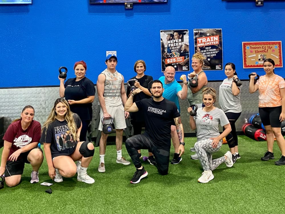 gym members pose for a picture after a small group training boot camp at freedom fitness calallen