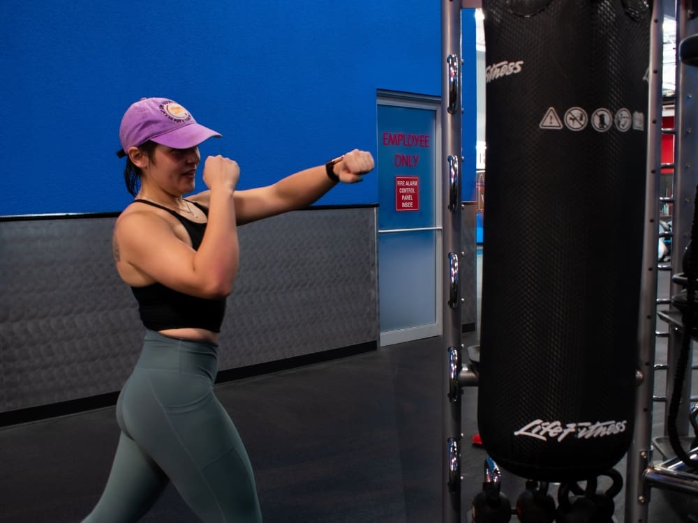 a woman uses a punching bag in a womens only gym area at freedom fitness gym in calallen