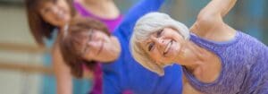 older woman in a yoga class in a modern gym