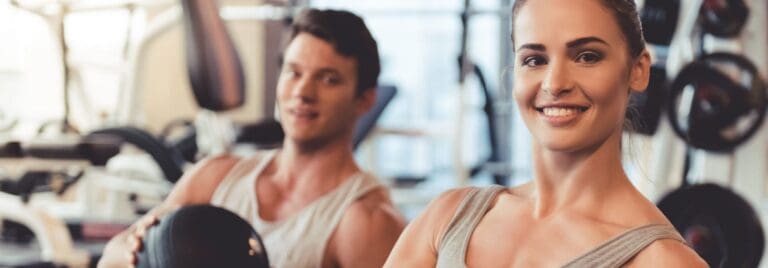 man and woman working out in a modern gym