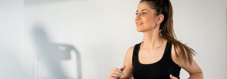 woman working out on a cardio machine