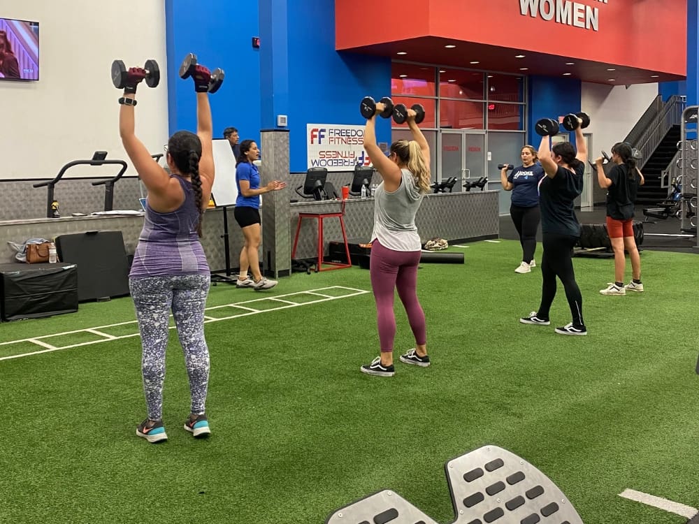 gym members work out on a functional training turf during a small group training bootcamp at a corpus christi gym