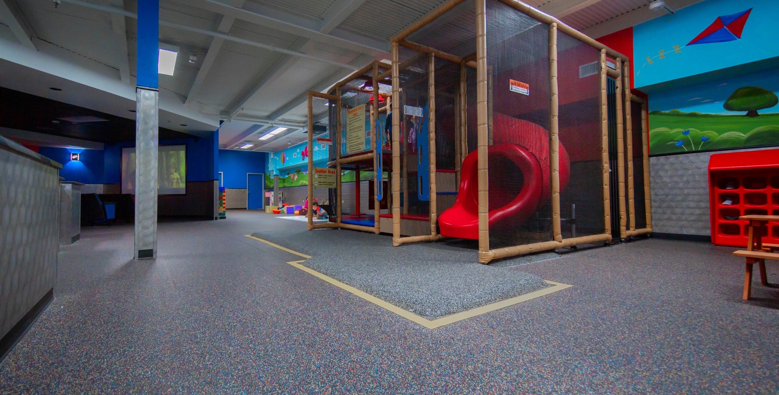 a slide and play area inside the onsite childcare facility at freedom fitness corpus christi gym near me