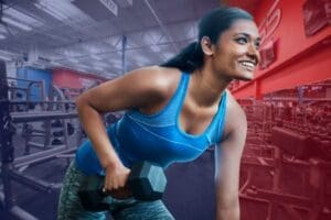 woman in gym working out with free weights