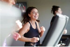 Woman doing cardio on treadmill at Freedom Fitness in Corpus Christi.